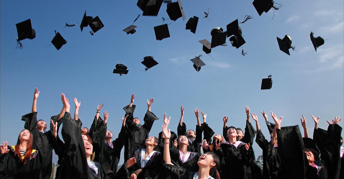 pexels photo 267885 267885 Group of graduates celebrating by throwing caps in the air during a sunny day.